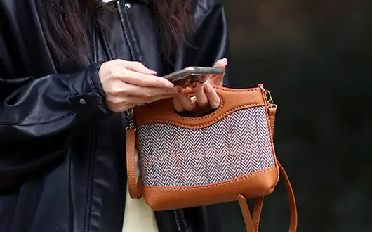Handheld style display of patchwork bag Handheld style display of patchwork bag